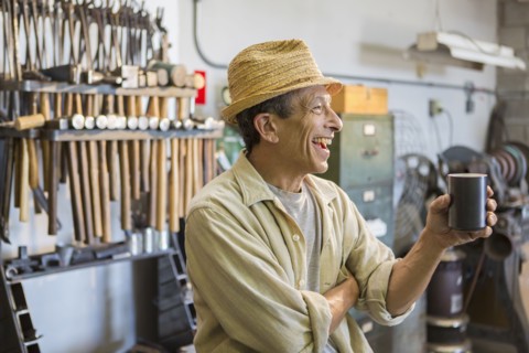 Middle Eastern man smiling in workshop