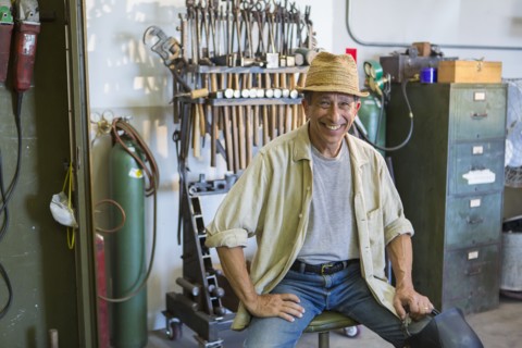 Middle Eastern man smiling in workshop