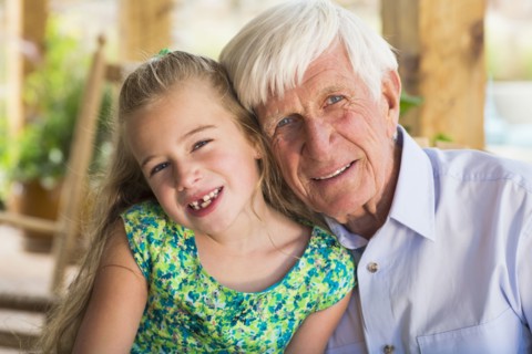 Caucasian man and granddaughter smiling