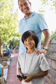 Father and son smiling outdoors