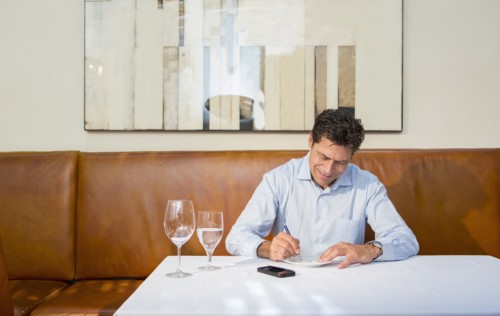 Caucasian businessman working at restaurant