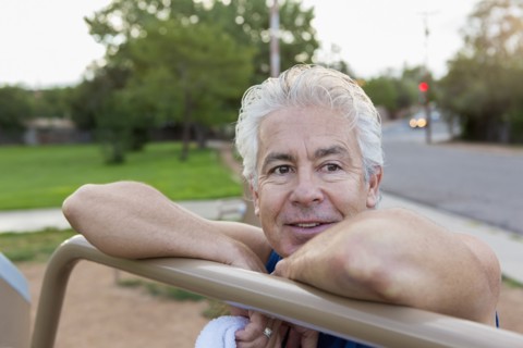 Older Hispanic man exercising in park