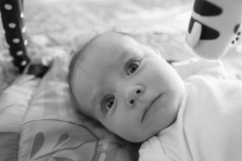Caucasian baby boy laying on blanket