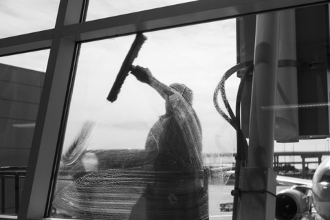 Window washer cleaning window