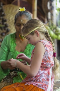Girl learning Balinese weaving