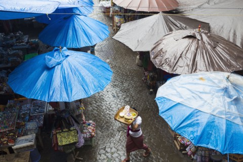 Rain falling over tarps and awnings of market stalls