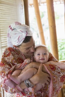 Caucasian mother cradling baby