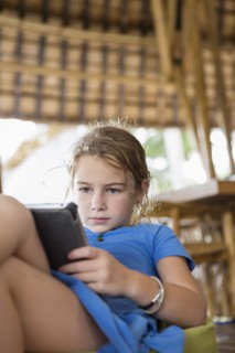 Caucasian girl using digital tablet on patio
