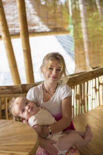 Caucasian girl holding baby sibling
