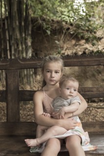 Caucasian girl holding baby boy outdoors