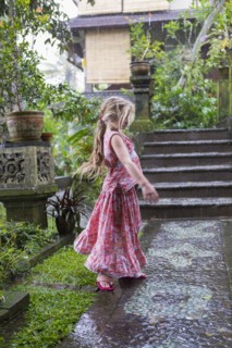 Caucasian girl dancing on wet patio