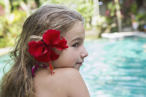 Caucasian girl with hibiscus flower in hair