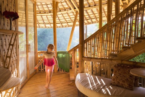 Caucasian girl walking in bamboo living room