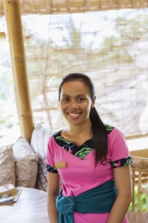 Balinese maid smiling on hotel patio