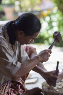 Wood worker chiseling piece in studio