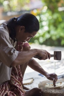Wood worker chiseling piece in studio
