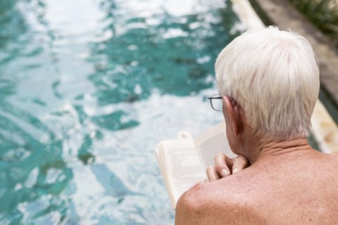 Senior Caucasian man examining swimming pool