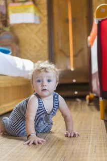 Caucasian baby crawling in bedroom