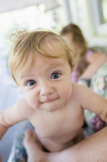 Caucasian baby grimacing