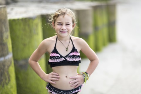 Caucasian girl wearing bikini on beach