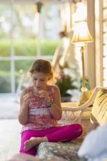 Caucasian girl sitting on patio