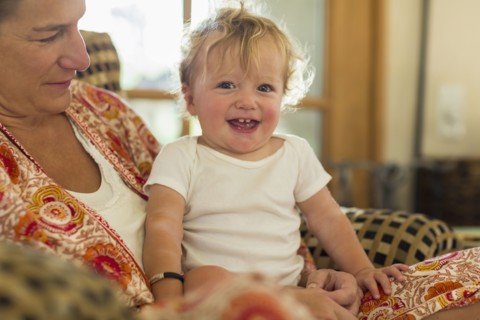 Caucasian mother holding toddler in living room