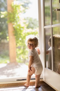 Caucasian toddler standing in doorway