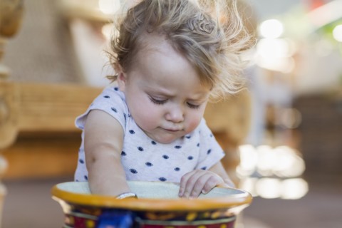 Caucasian toddler digging in bucket