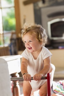 Caucasian toddler standing in living room