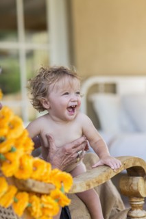 Caucasian boy sitting in lap of grandmother