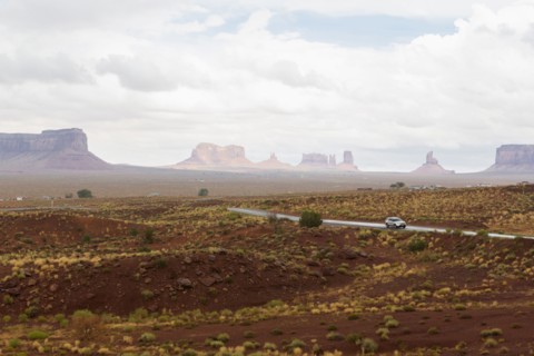 Rock formations and remote road in desert landscape