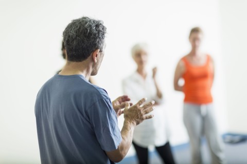 Teacher talking to students in acting class