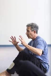 Caucasian teacher gesturing in acting class