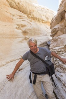 Older Caucasian man exploring rock formations