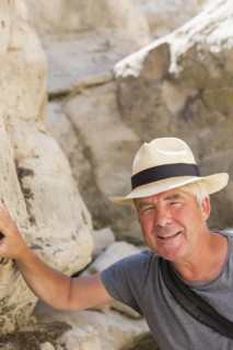 Older Caucasian man exploring rock formations