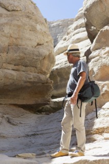 Older Caucasian man exploring rock formations