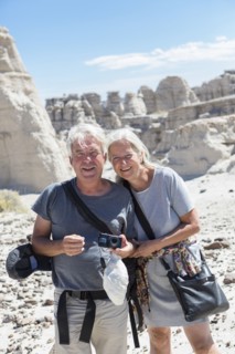 Older Caucasian couple exploring rock formations