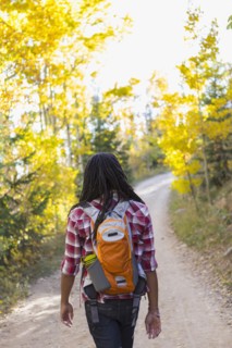Mixed race man hiking in forest