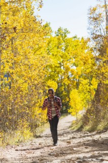 Mixed race man hiking in forest