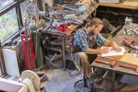 Caucasian craftsman working in workshop