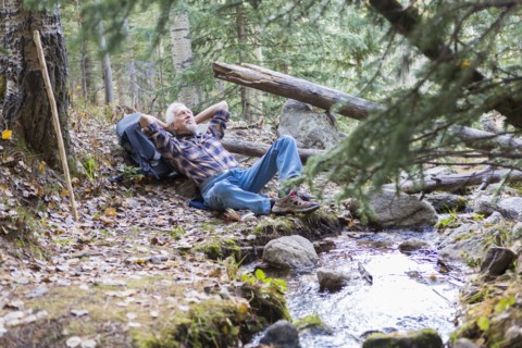 Caucasian hiker resting in forest