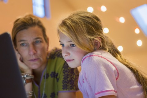 Caucasian mother and daughter using computer together