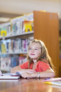 Caucasian student sitting at desk in library