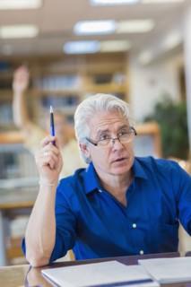 Adult student raising his hand in class