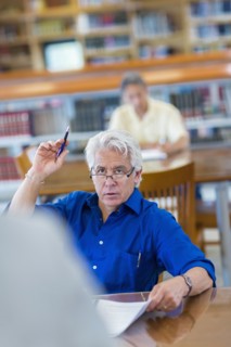 Adult student raising his hand in class