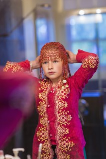 Caucasian girl wearing beaded cap