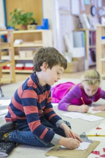 Caucasian children writing in classroom