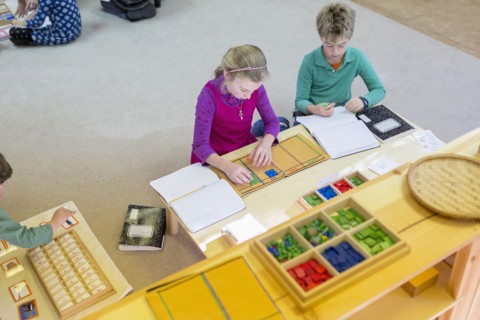 Caucasian children at table in classroom