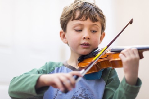 Close up of boy playing violin