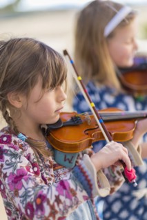 Close up of girls playing violin